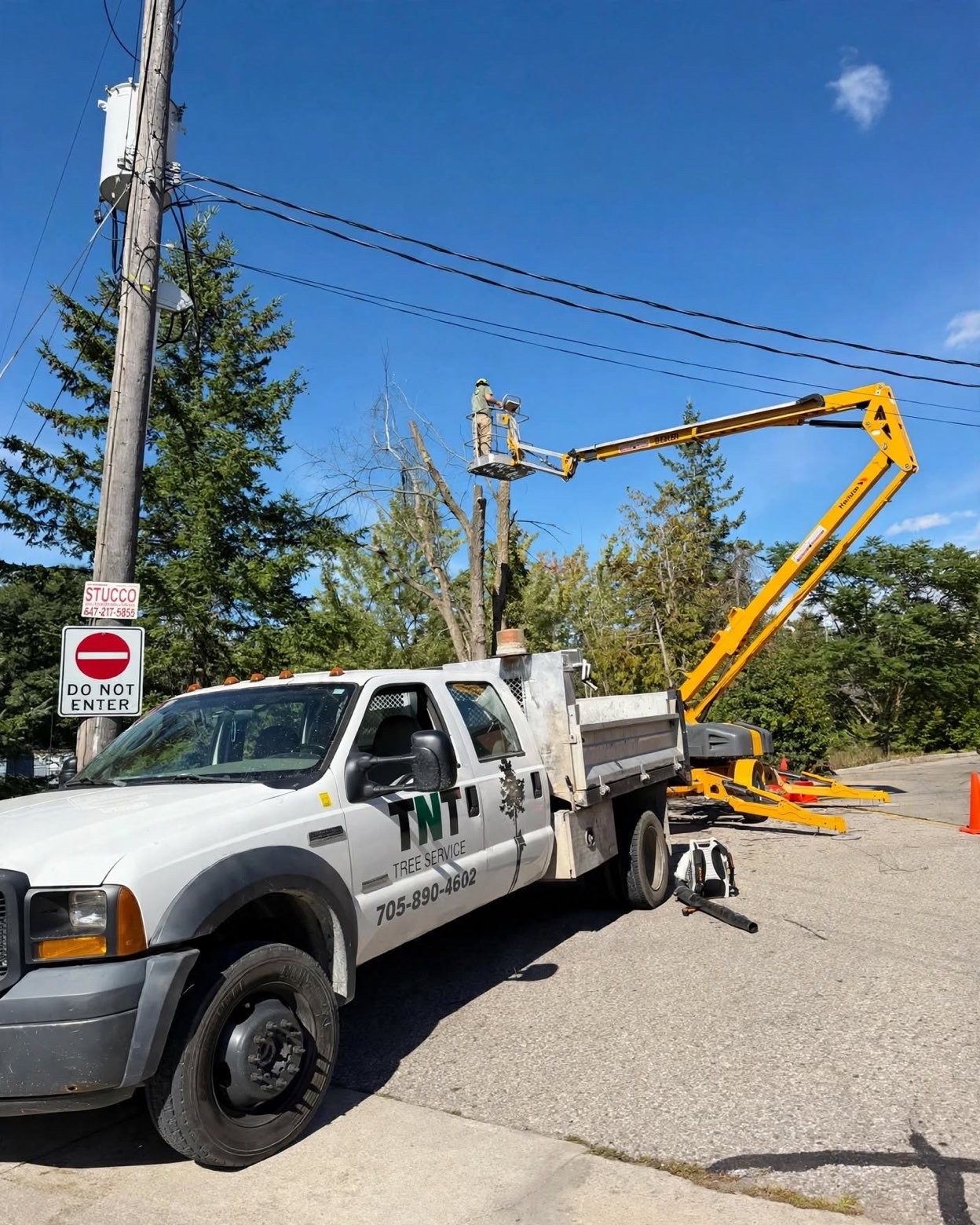 Bucket truck set up beside hydro lines